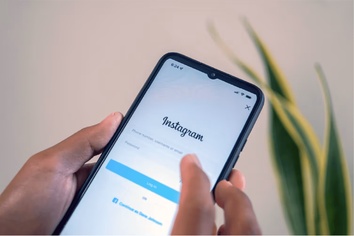 social media: holding phone with instagram login