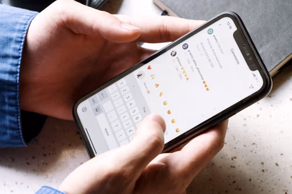Hands holding phone commenting on app