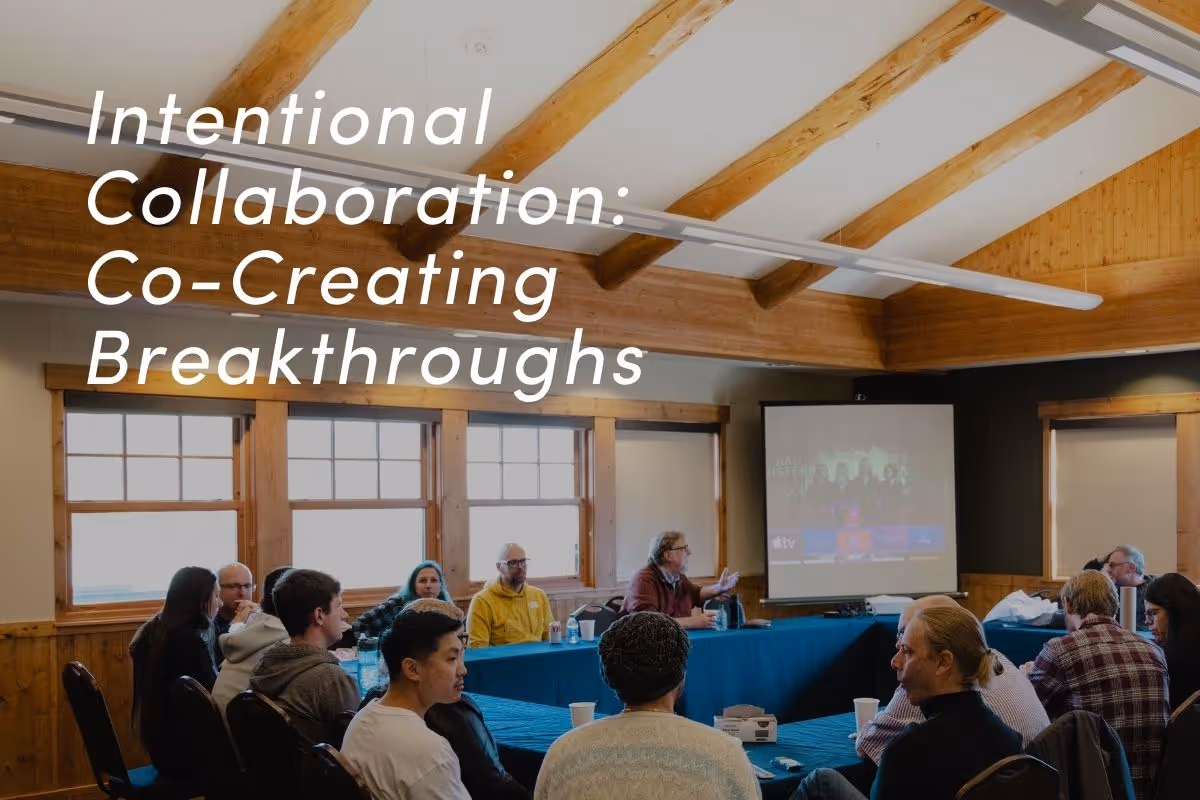 Team meeting in wooden conference room with presentation screen, demonstrating intentional collaboration for breakthrough innovation.