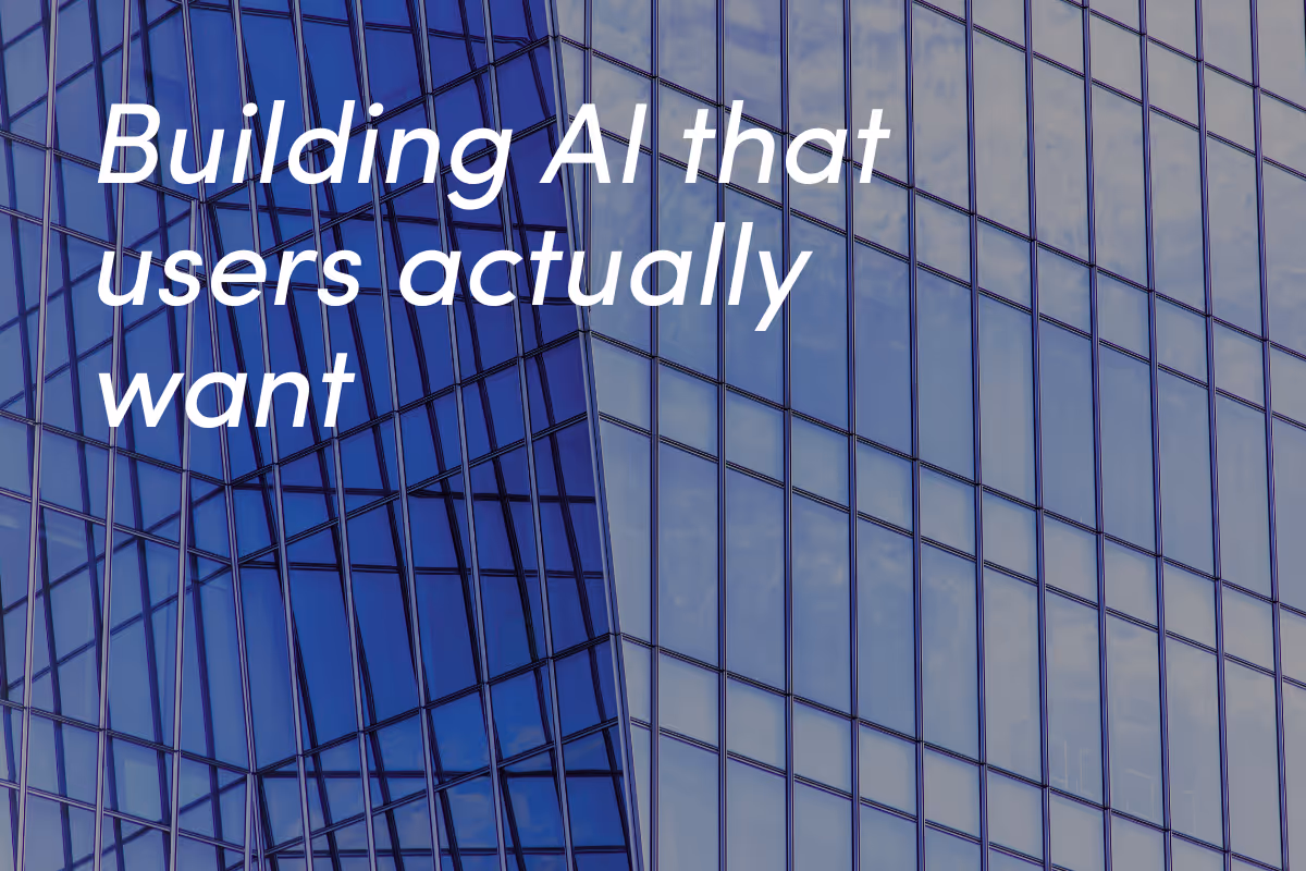 Modern blue glass building facade with geometric grid pattern and sky reflections.