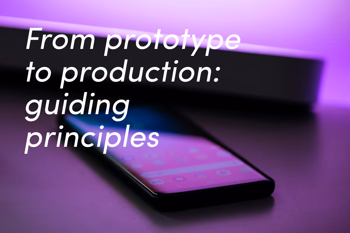 Black smartphone lying on reflective surface with purple and pink gradient lighting.