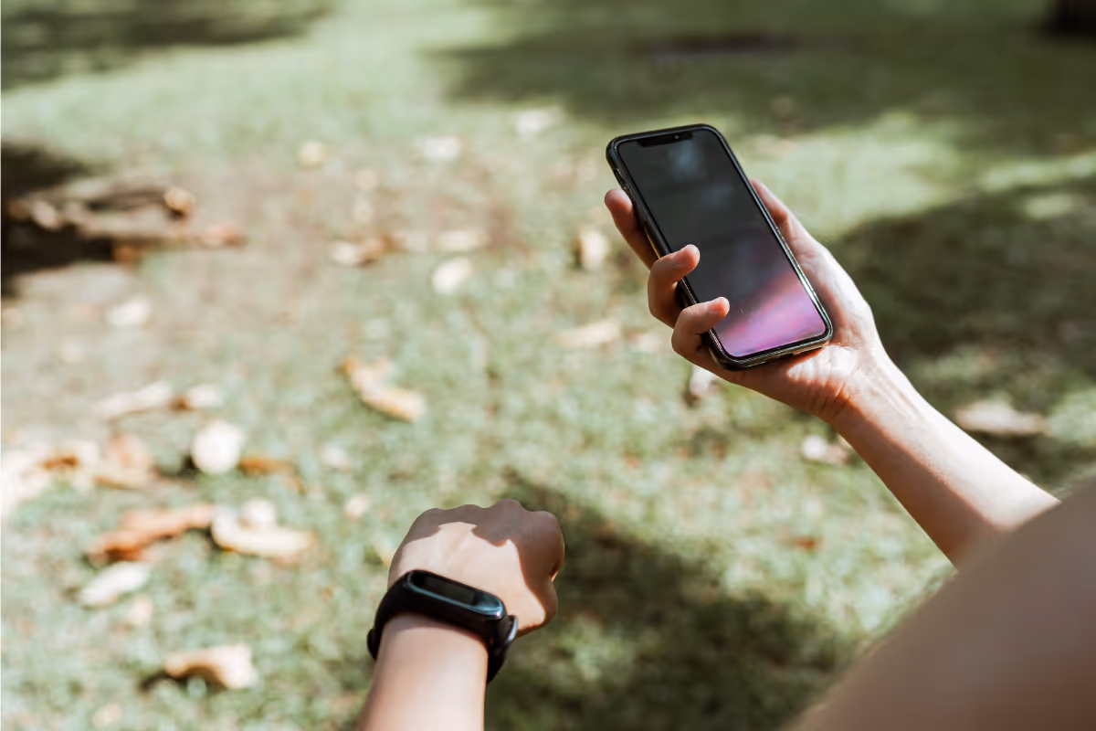 Mobile app user testing new features outdoors with smartphone and smartwatch technology
