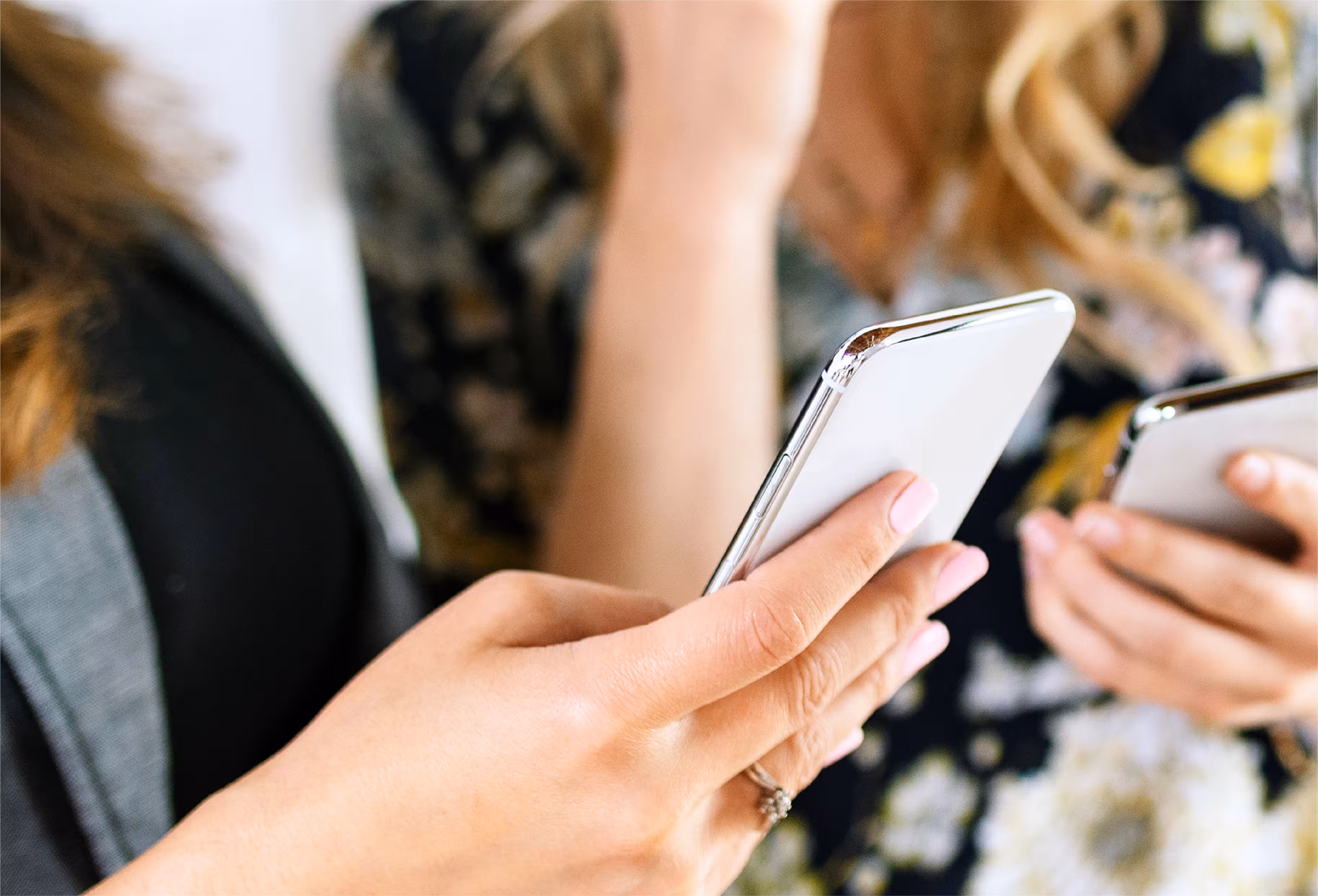 Two people using mobile phones for digital payment