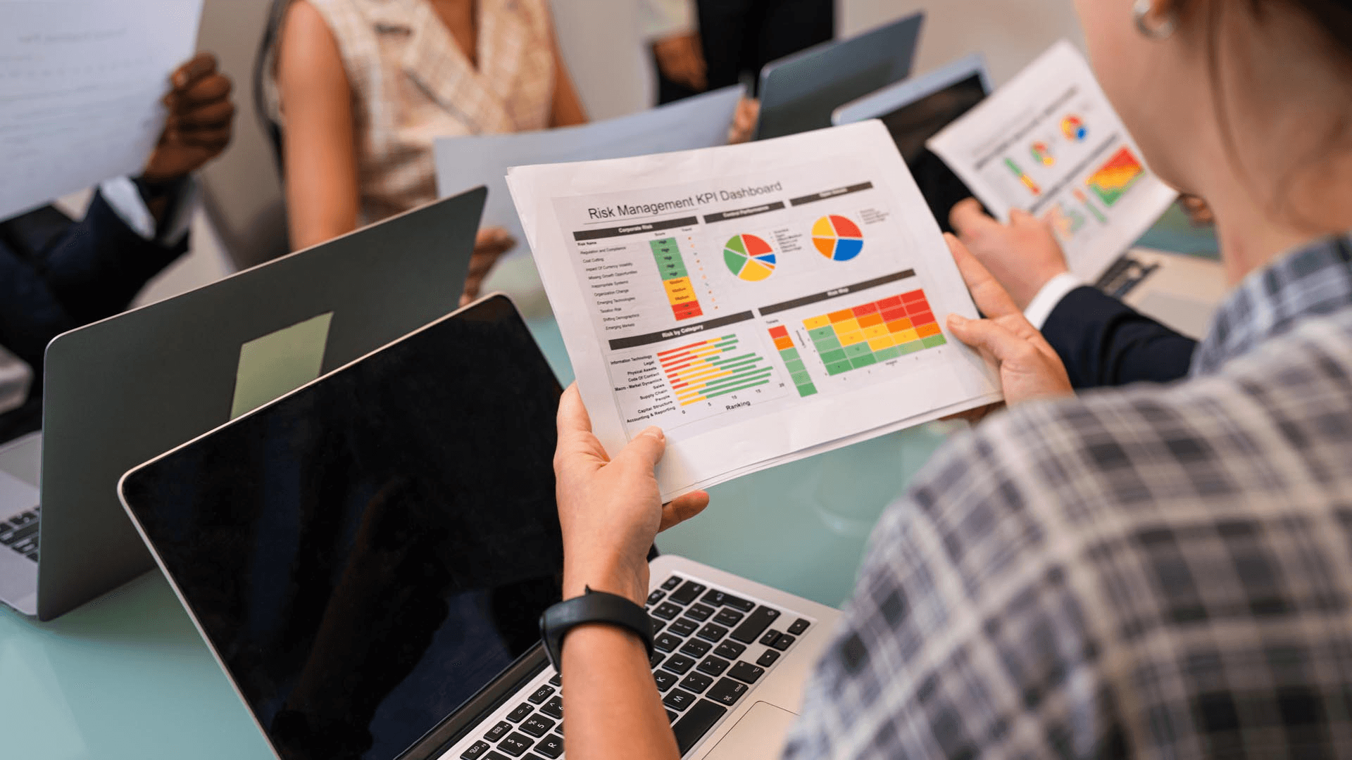 People reviewing a risk management dashboard - How to Improve NPS Score