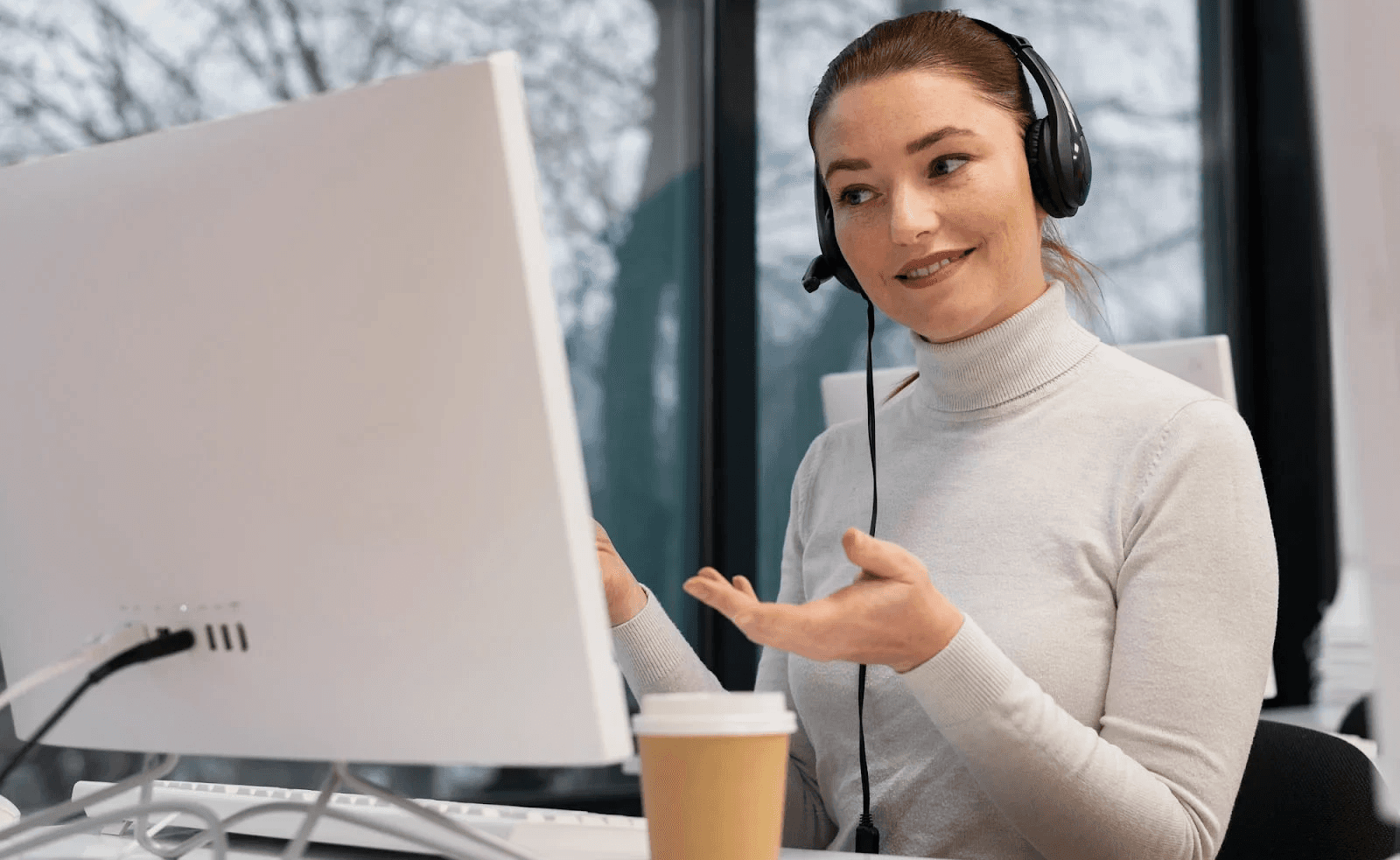 Woman wearing headsets - How to Improve CSAT Scores in a Call Center