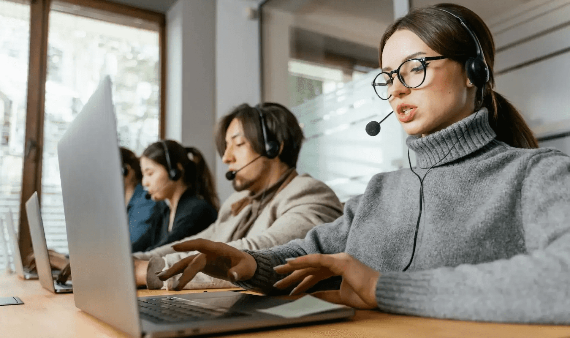 People working in a call center - How to Improve CSAT Scores in a Call Center