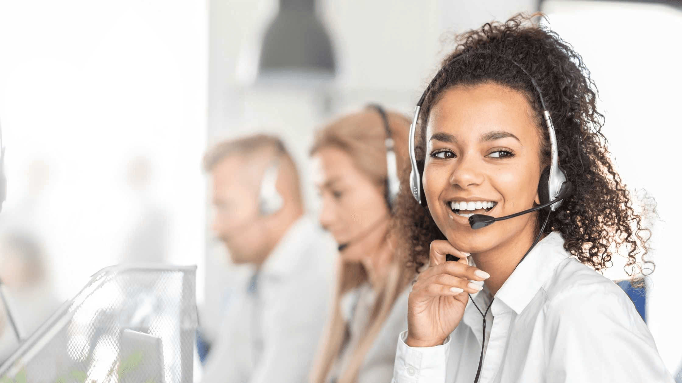 Smiling woman working in call center - How Do You Manage Inbound Calls?