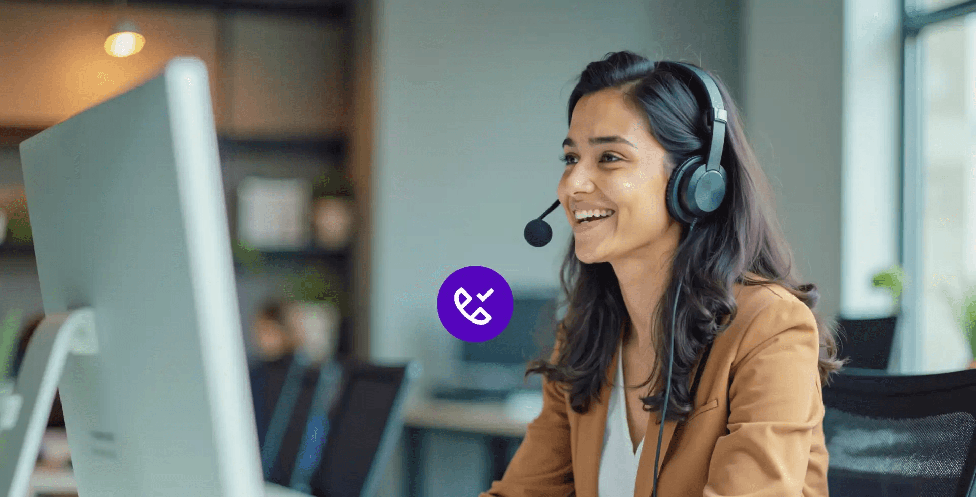 Woman wearing headset in office - How to Improve First Call Resolution