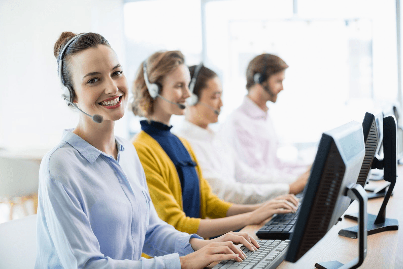  Customer service team working in office - How to Reduce After-Call Work in a Call Center