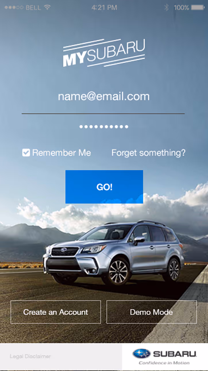 MySubaru login screen with email and password fields, remember me checkbox, and a silver Subaru SUV on a road with mountains in the background.