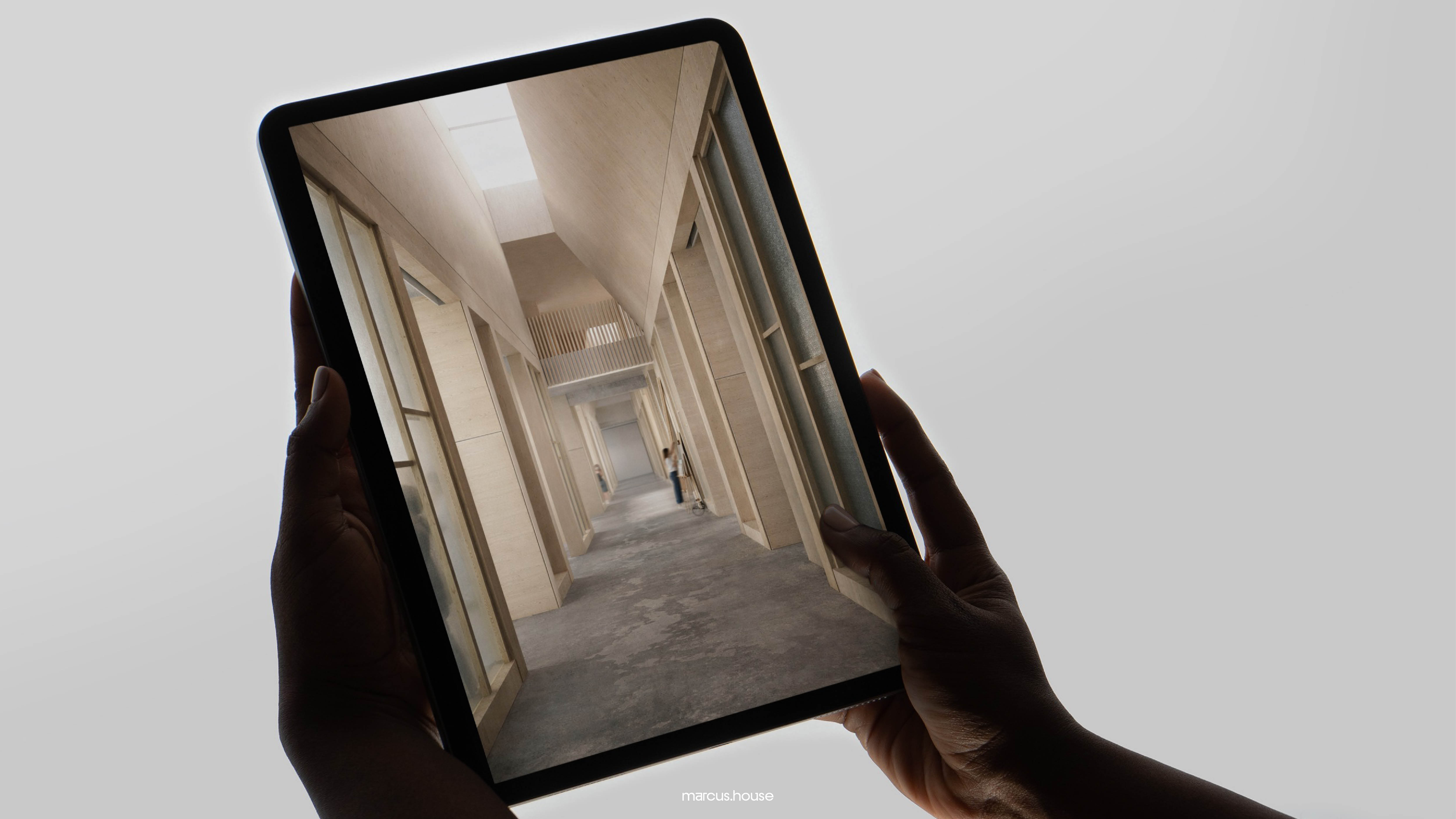 Hands holding a tablet showing a visualisation of a long timber-lined corridor
