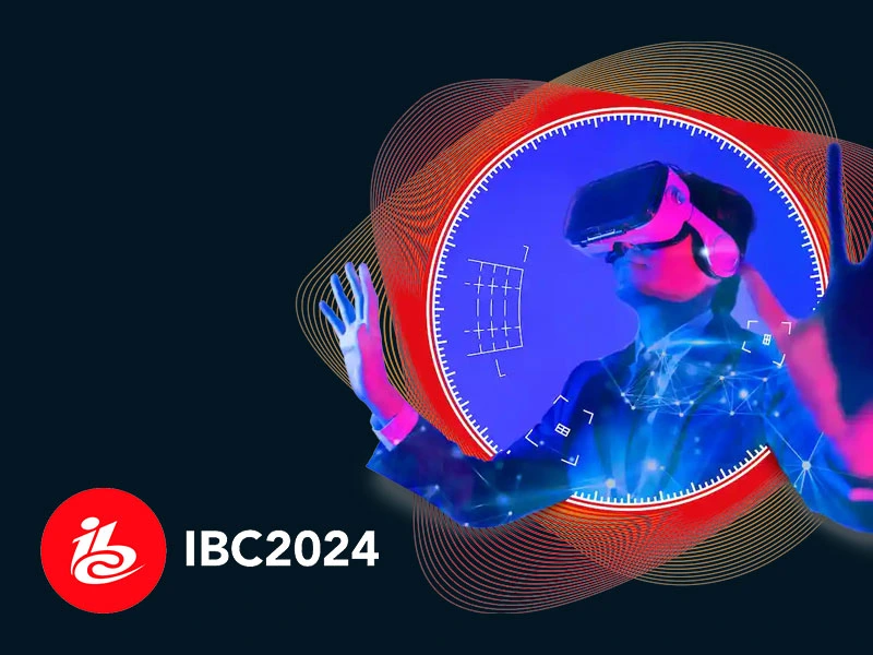 Promotional graphic for IBC2024 featuring a stylized image of a man wearing a VR headset, surrounded by futuristic digital overlays and red-gold abstract waveforms. The IBC logo appears in the bottom-left corner with the text 'IBC2024' on a dark blue image