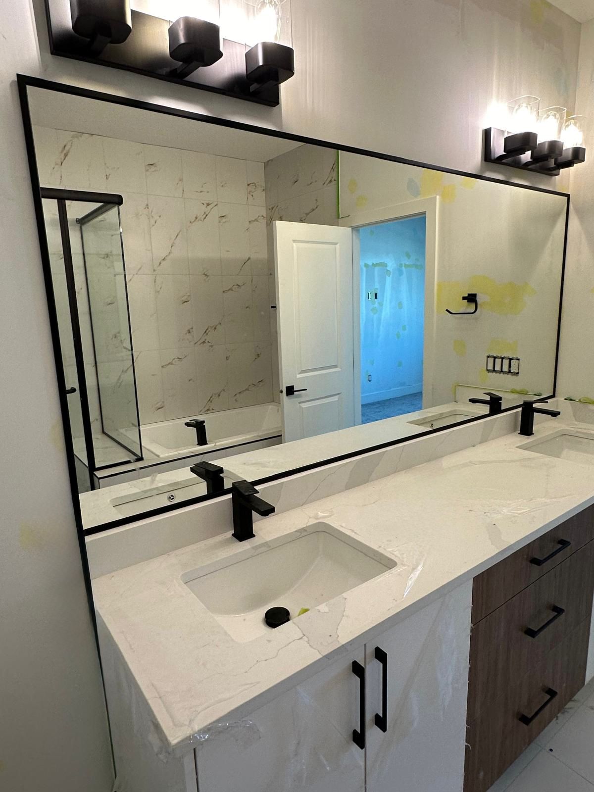 Black framed mirrors installed in bathroom