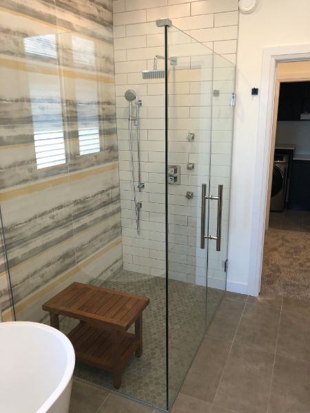 Custom glass shower enclosure with fitted hardware