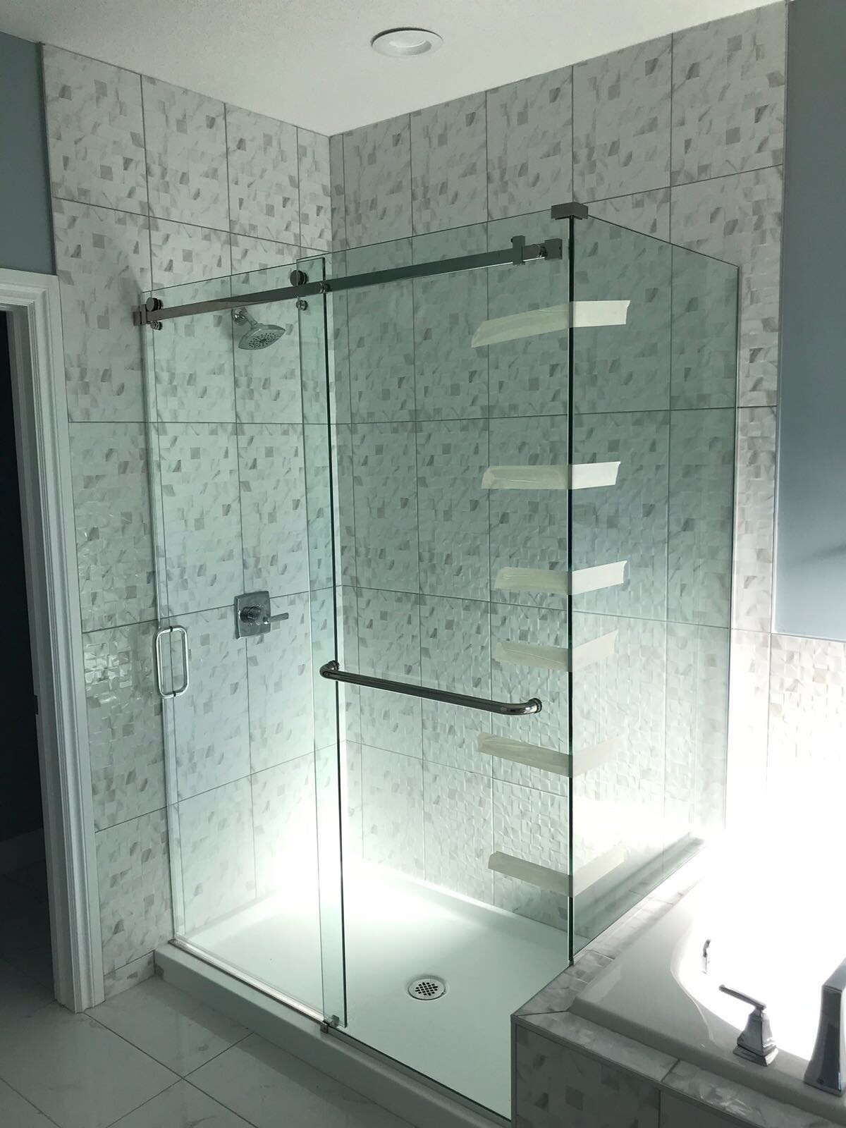 Custom glass shower enclosure with fitted hardware