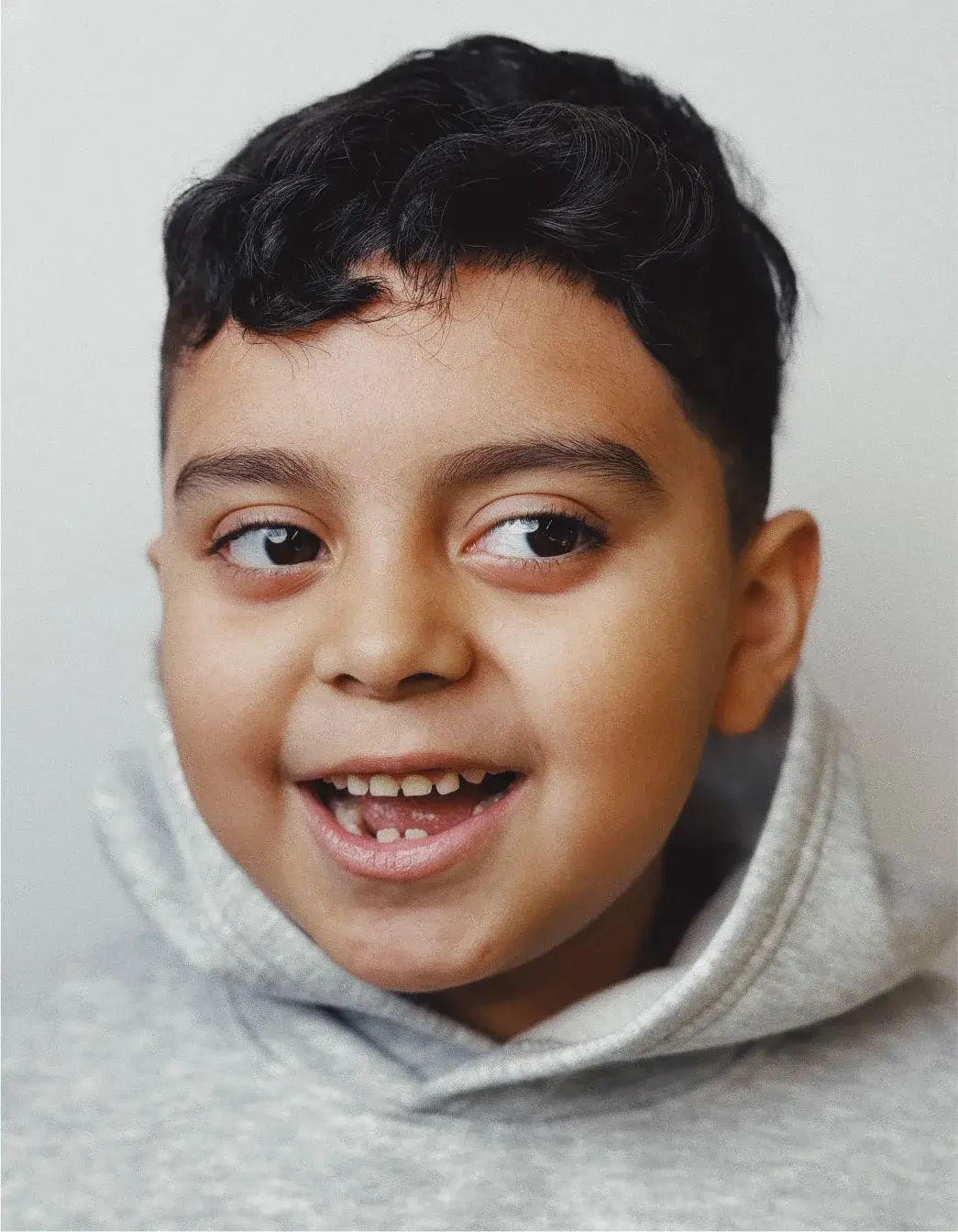 A young boy with a smile on his face.