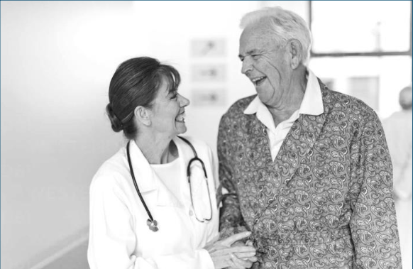 Physician and senior citizen laughing while walking