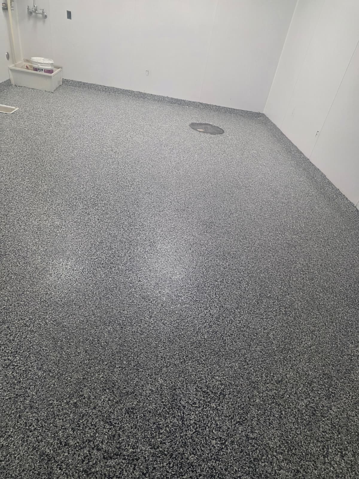 Flake epoxy floor with an integral cove base in a commercial utility room