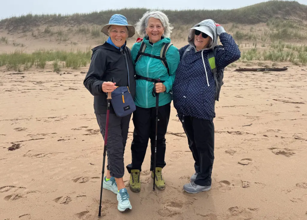 three ladies pose on pei beach