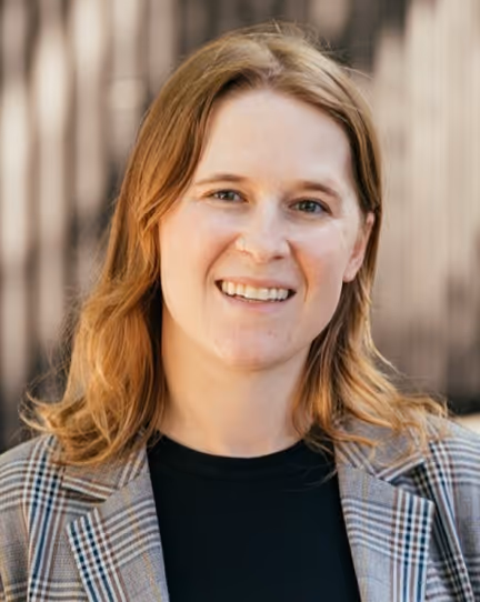 Dawn Androphy, Co-Founder of Allswell, smiling in a plaid blazer.