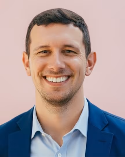 Connor Gordon, Co-Founder of Allswell, wearing a blue blazer and smiling.