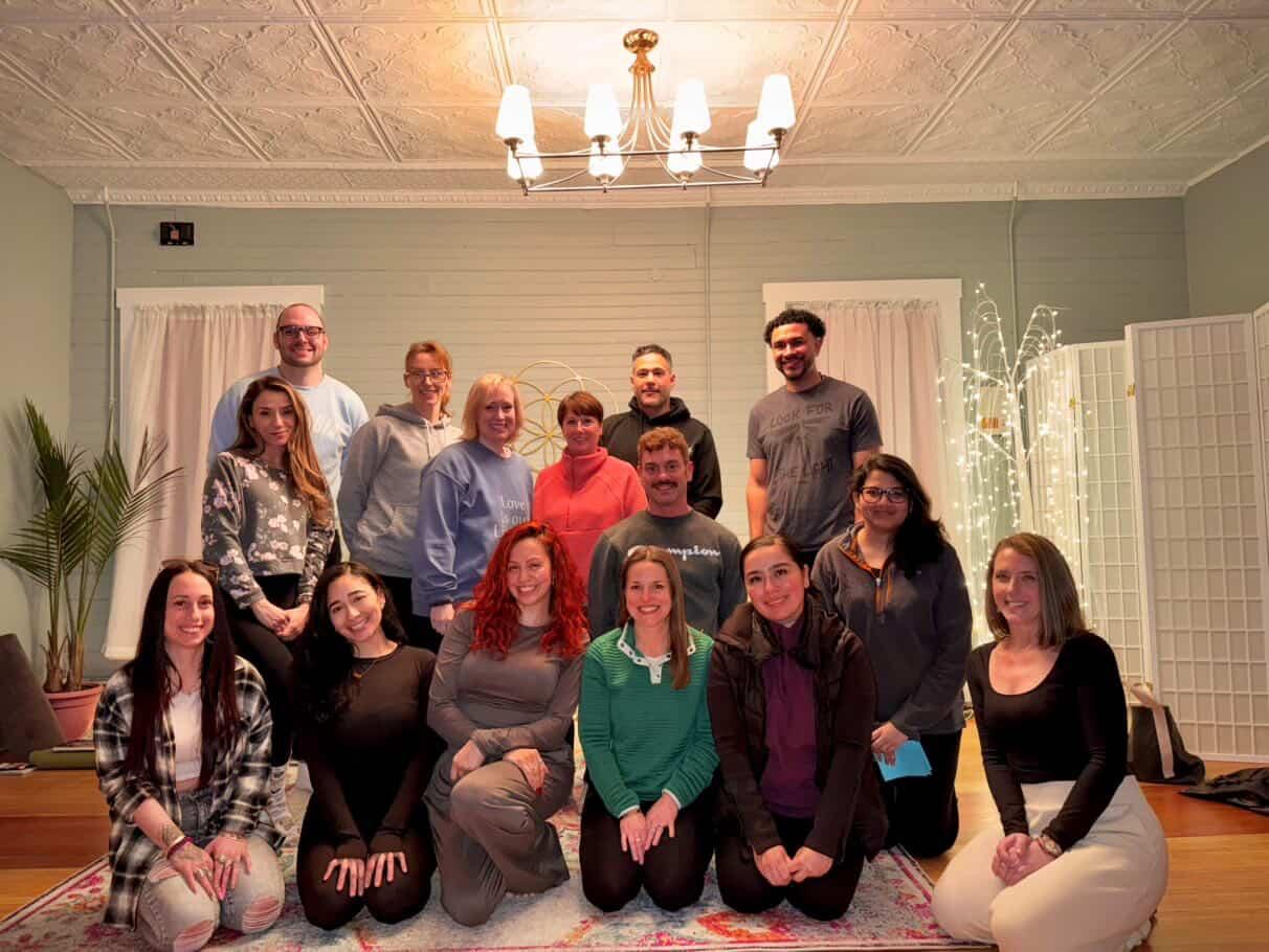Kendra playing crystal sound bowls during a sound bath
