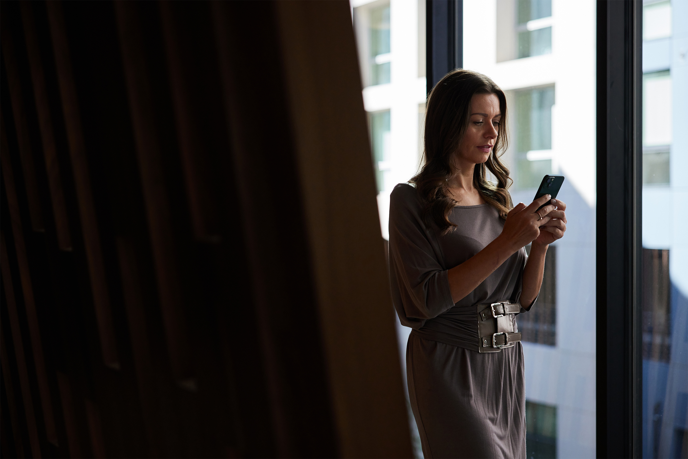 Lady looking at phone in office