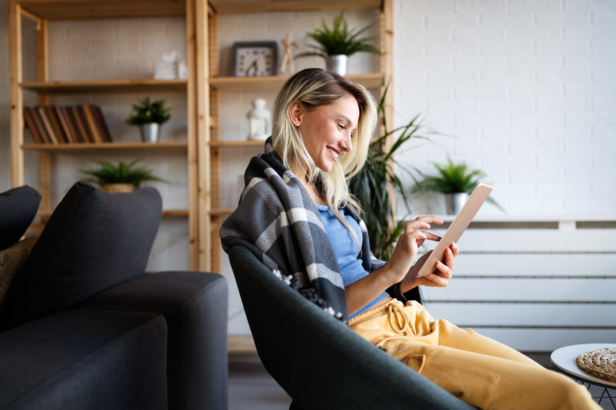 Woman looking at ipad smiling