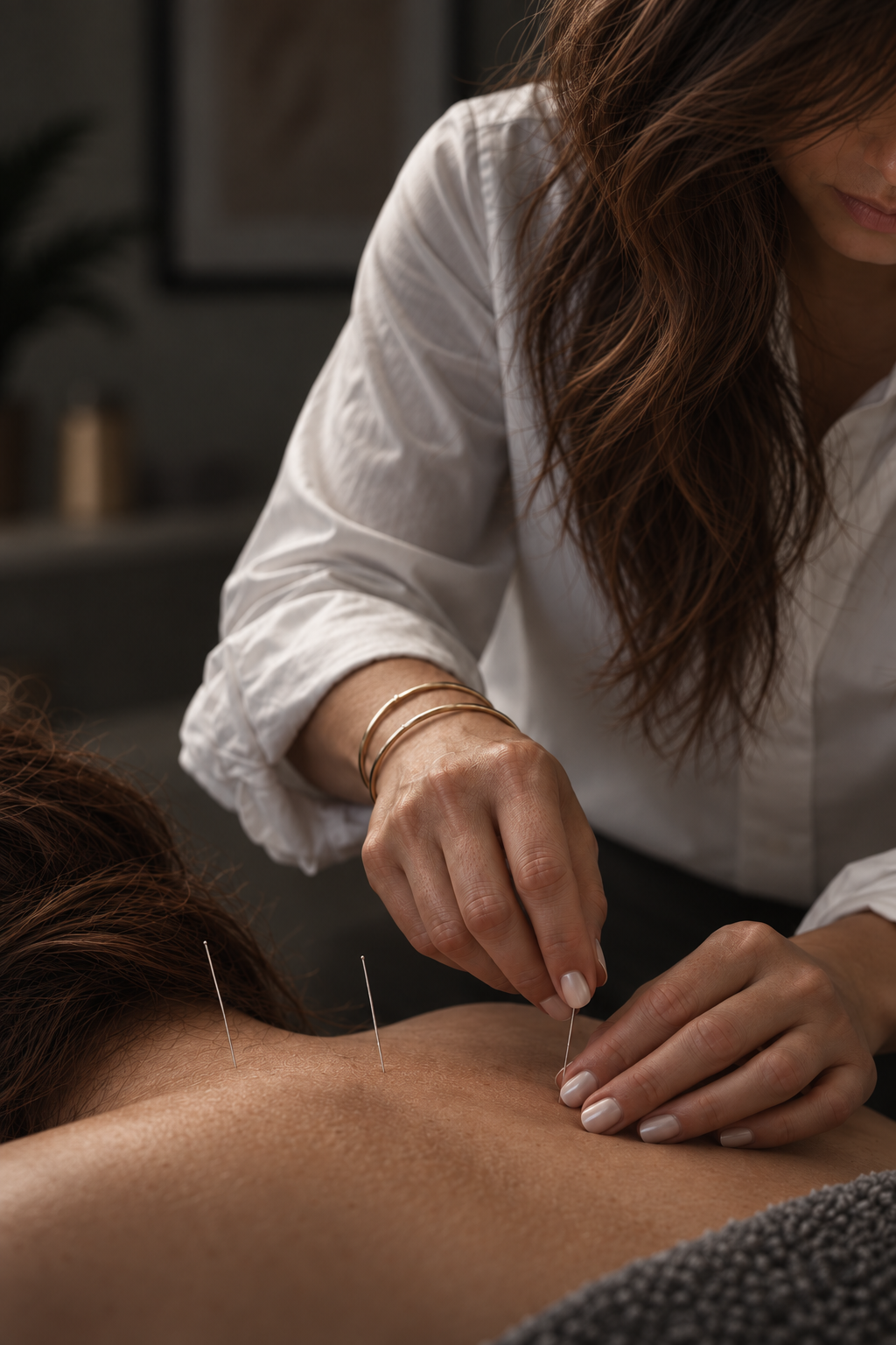 Close-up of acupuncture needles inserted into a patient's skin during treatment at a holistic clinic in Pittsburgh