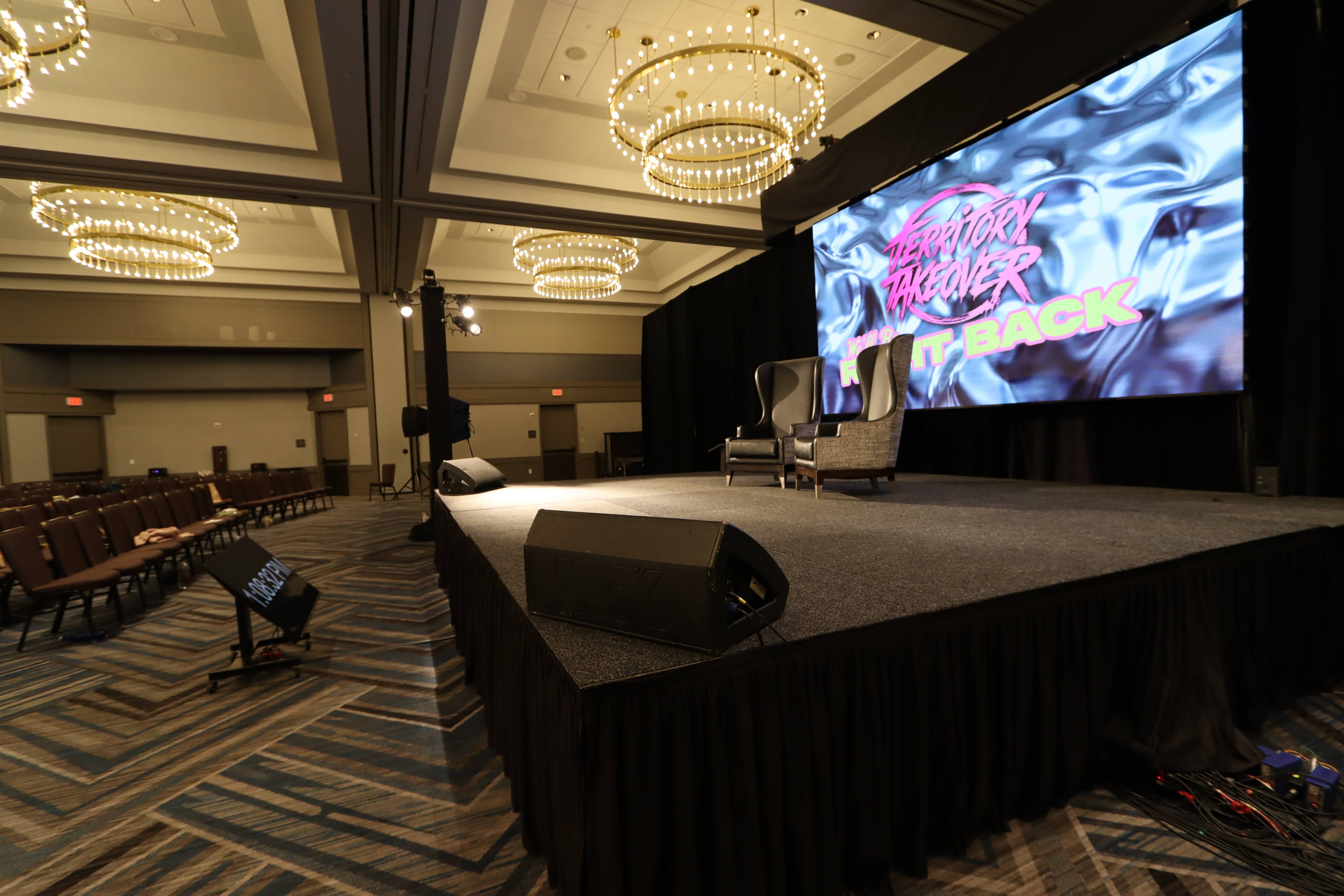 Corporate general session stage with LED video wall backdrop built by True Productions in an Atlanta ballroom