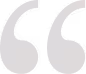 Stylized double quotation mark symbol in light gray.