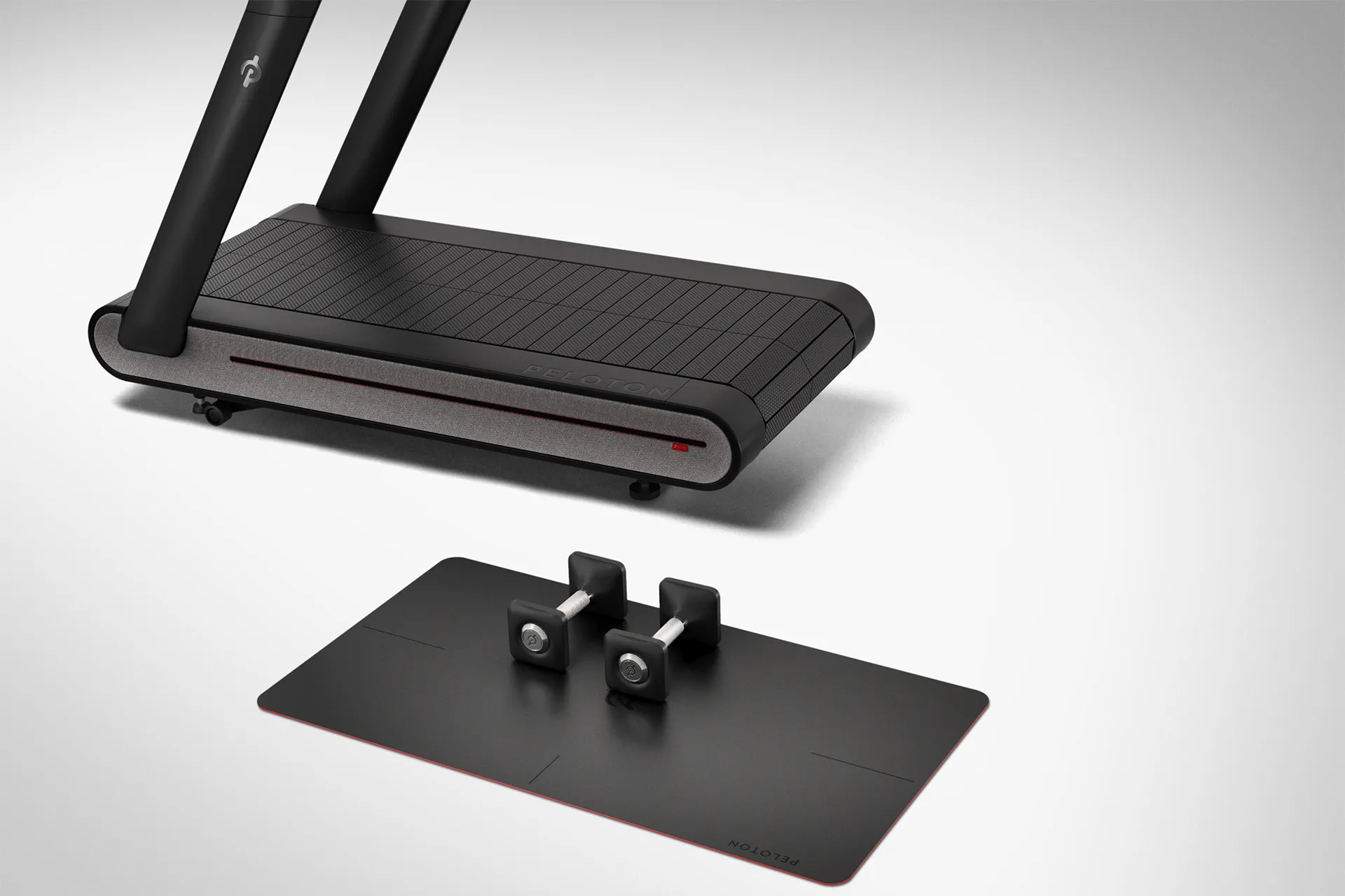 Detail shot of Peloton tread base and exercise mat in a white studio environment