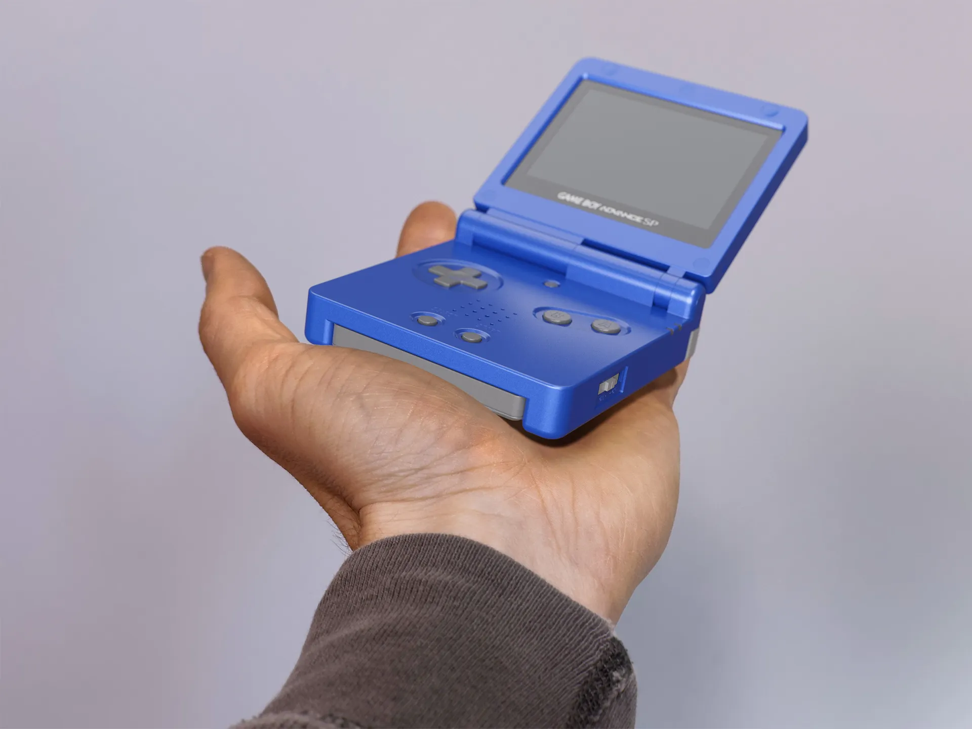 Blue Gameboy Advance open in a person's hand