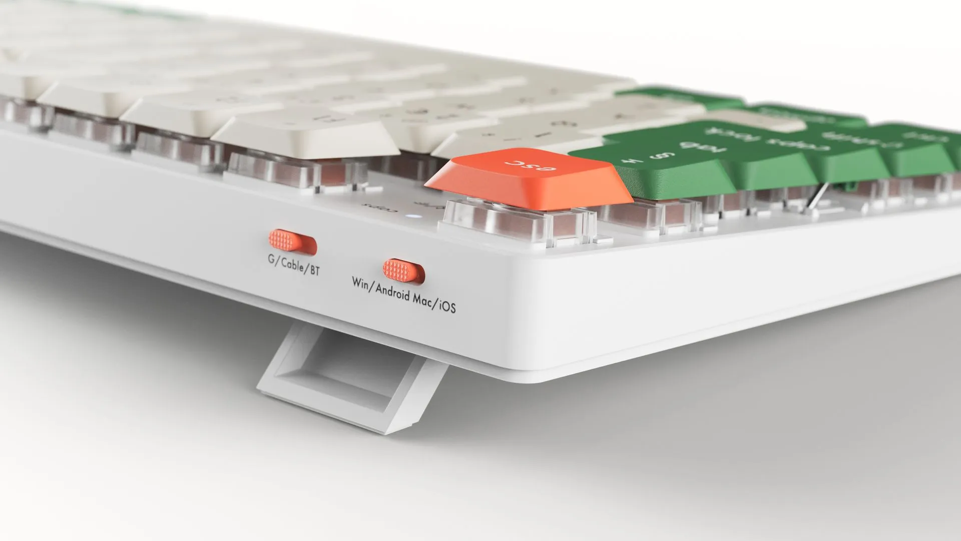 rear view of low profile computer keyboard in white with orange and green keys
