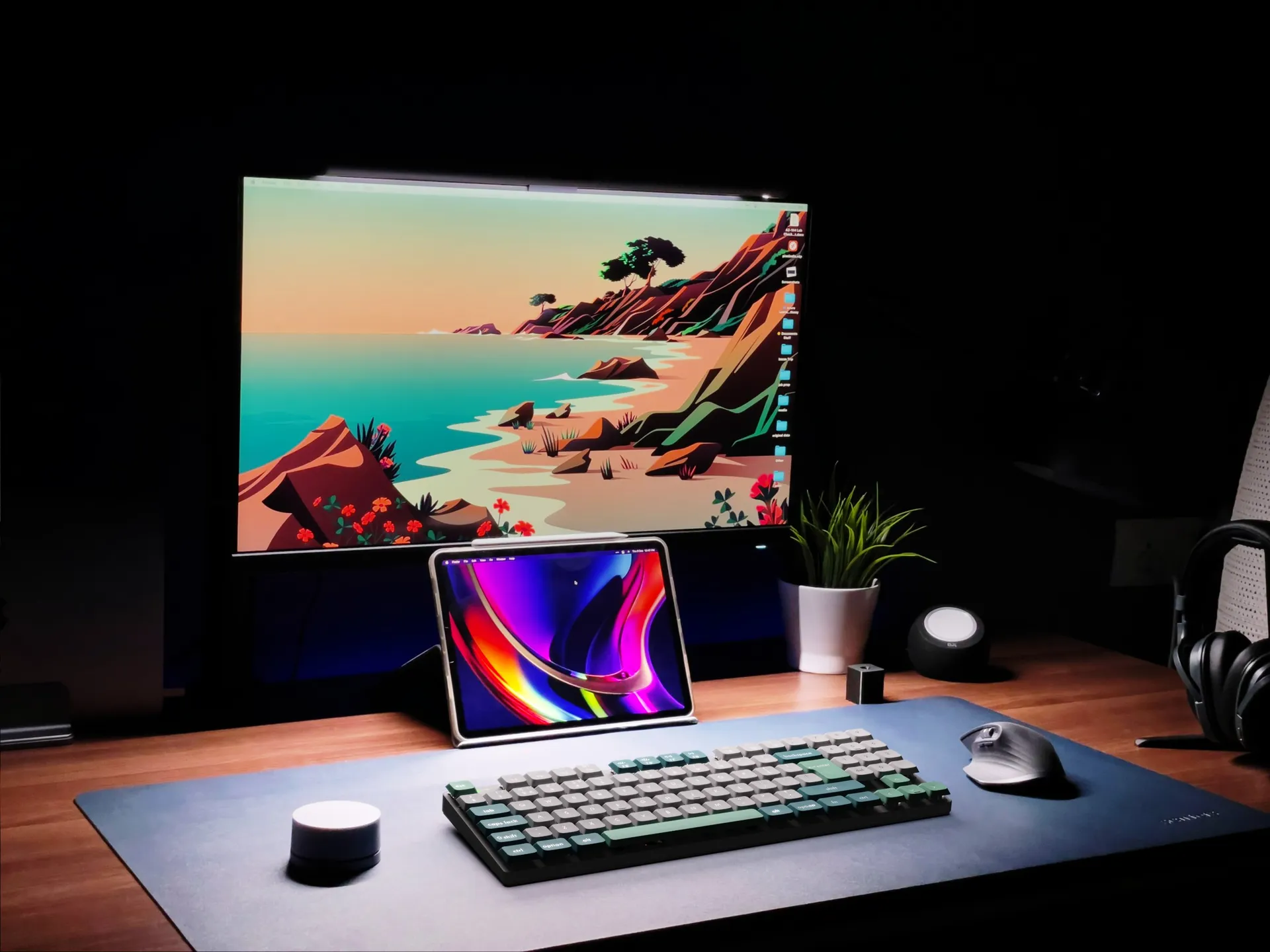 Dramatically-lit modern computer setup in dark room