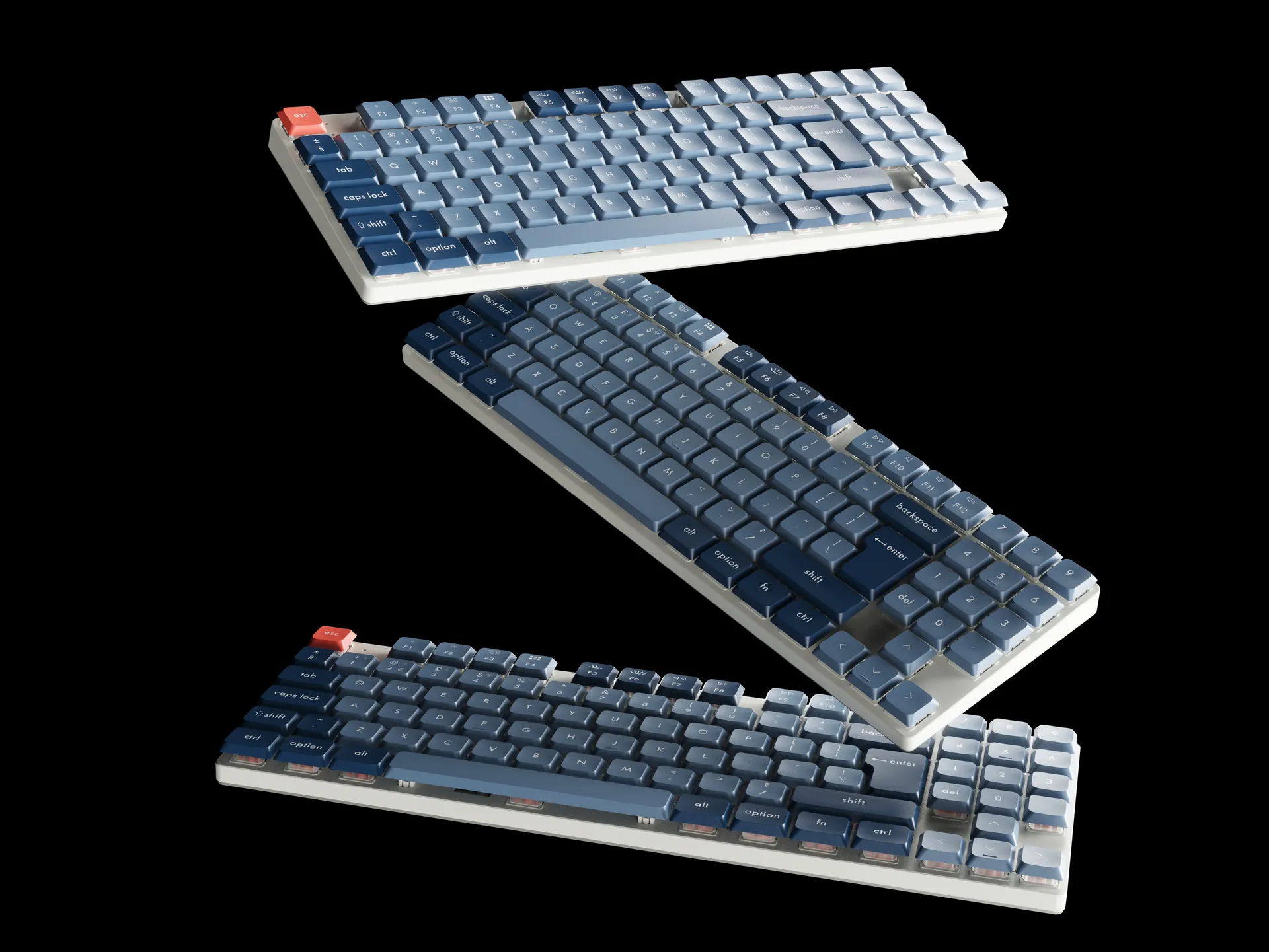 3 keyboards cascading on black background dramatic lighting