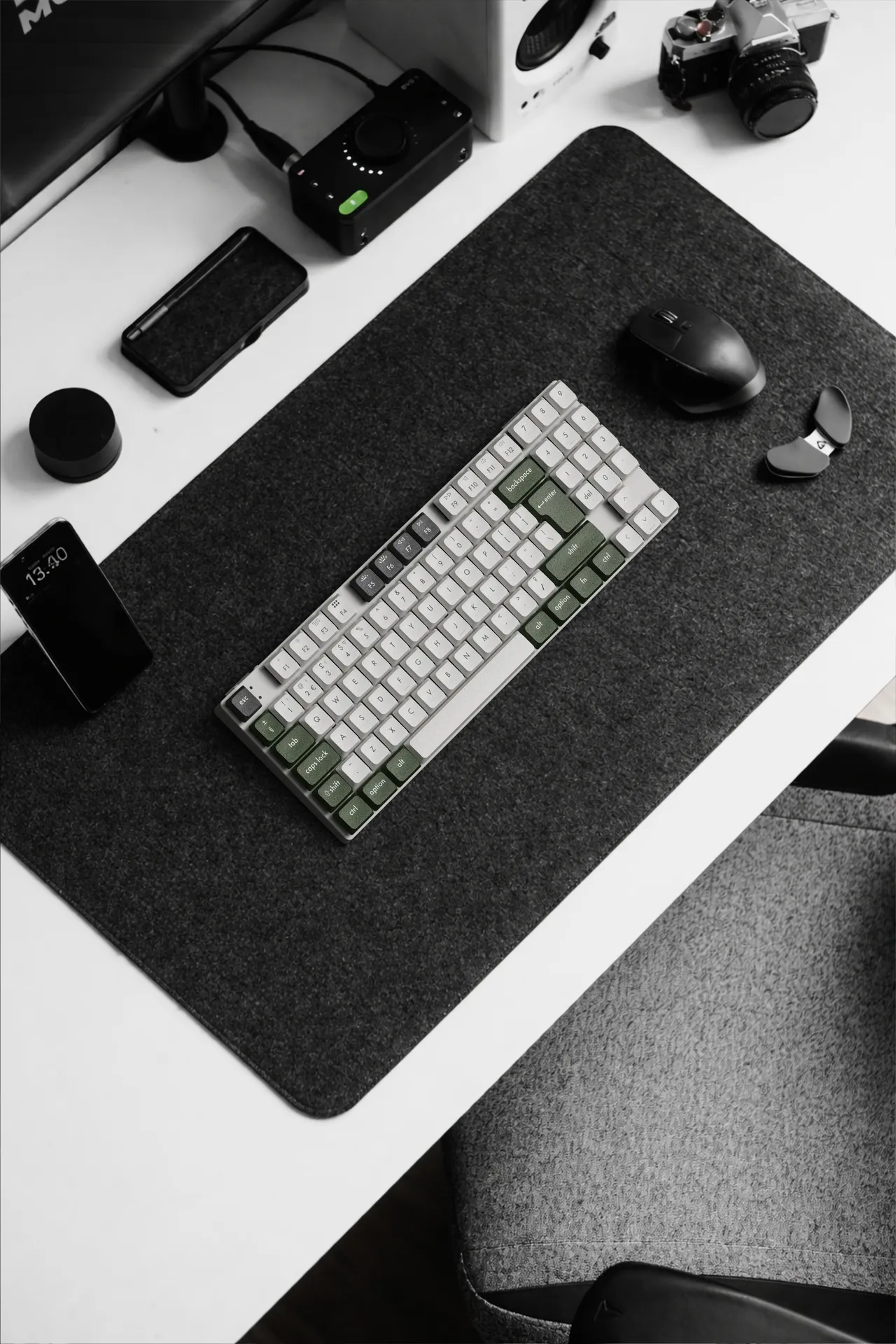 Birds eye view of modern desktop with computer and mechanical keyboard