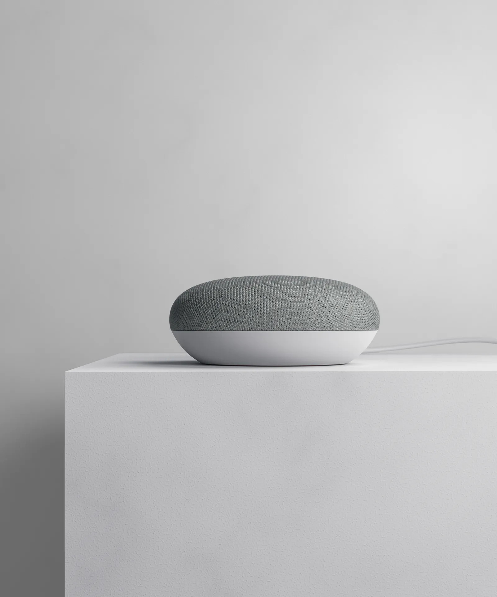 google home mini on white plinth