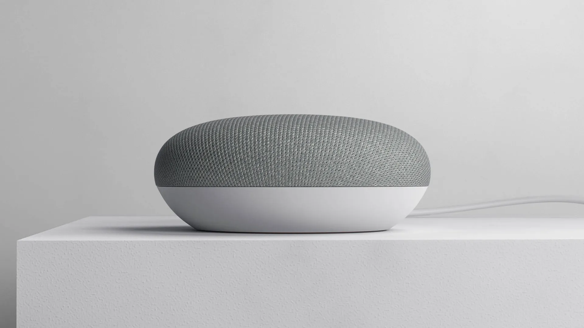 google home mini on white plinth studio environment