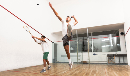 Two men playing tennis after their recovery from sports injury