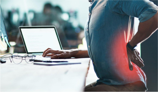 Man suffering from back pain at her work place
