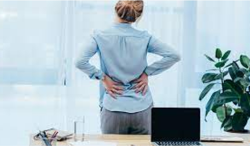 Women suffering from back pain at her work place