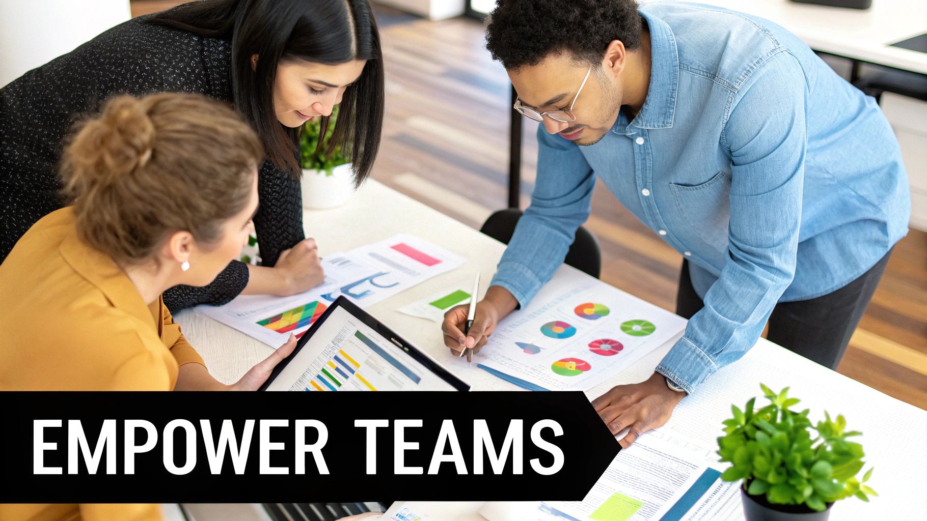 A group of diverse professionals collaboratively working around a table with charts and data visualizations, symbolizing a strong data culture and governance framework.