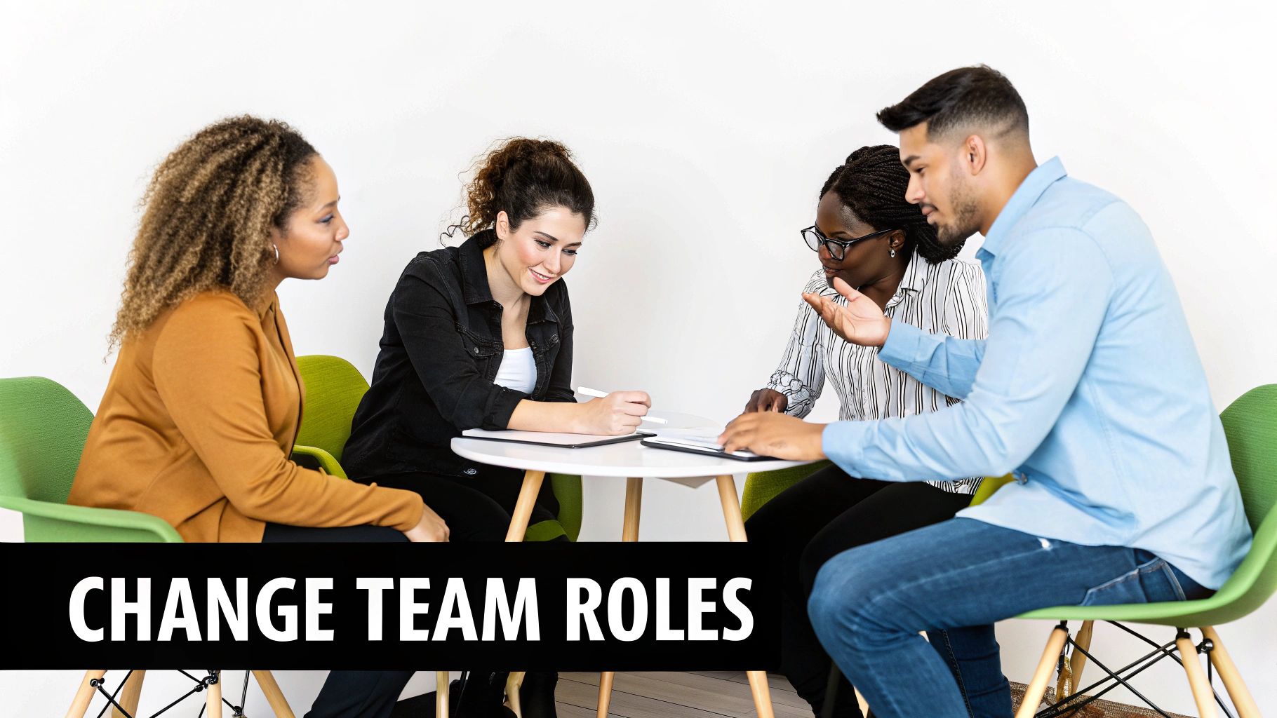 Diverse business team collaborating and discussing strategy around a table in a bright office.