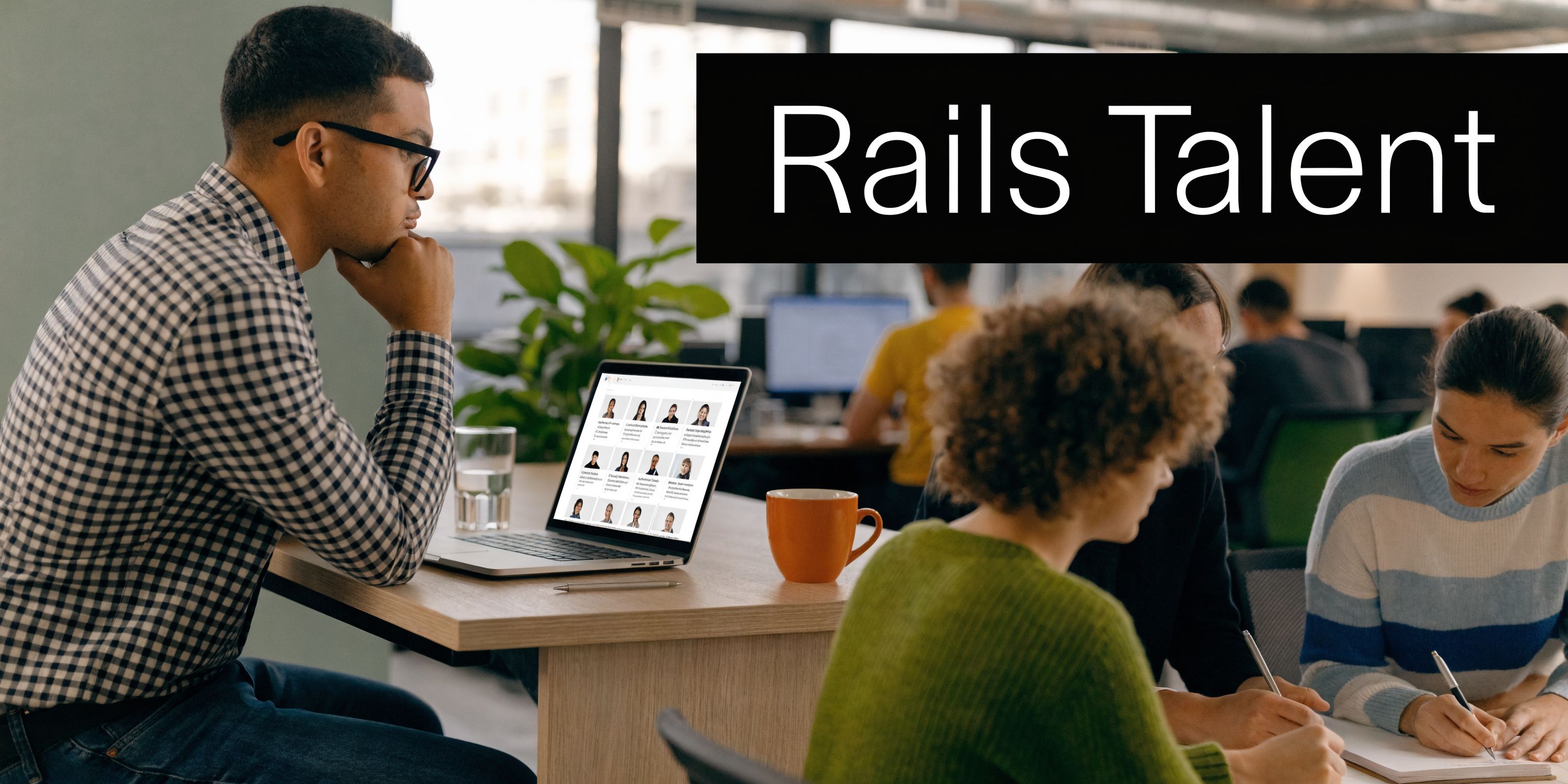 A diverse team of software developers collaborating on a project in a modern office workspace environment.