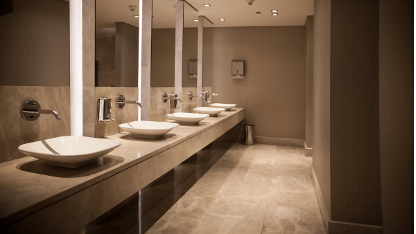 A hygienic and well-maintained restroom in a Miami restaurant, with clean sinks, mirrors, and floors, ensuring a safe and pleasant experience for patrons after a deep clean by Yeshua Cleaning.