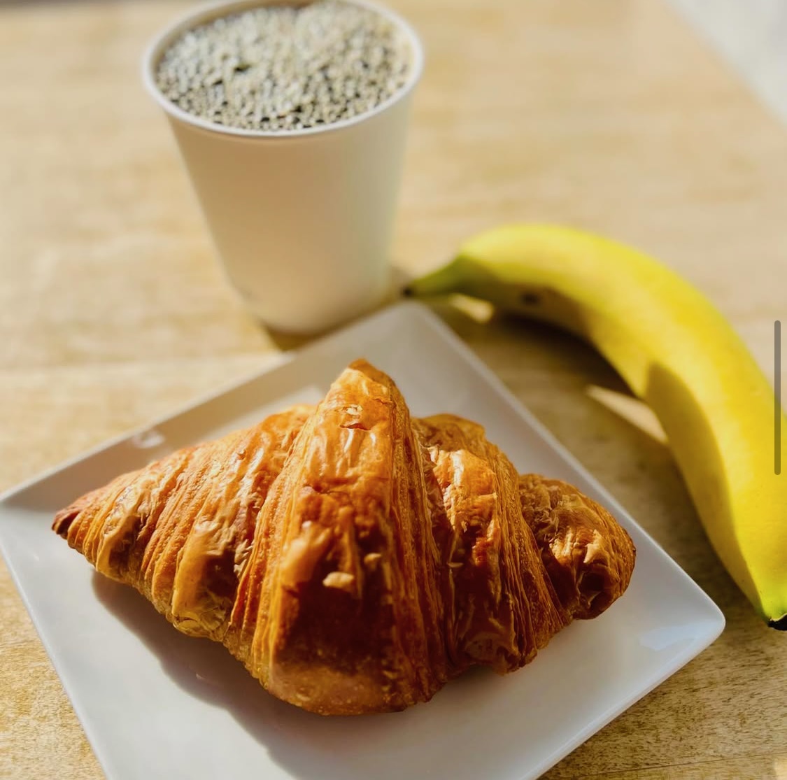 A croissant, a coffee, and a banana ready to go for a healthy breakfast at PB Boulangerie & Bistro in Wellfleet MA.