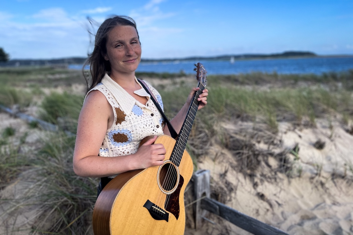 Natalia Bonfini and her guitar by the beach in Wellfleet.