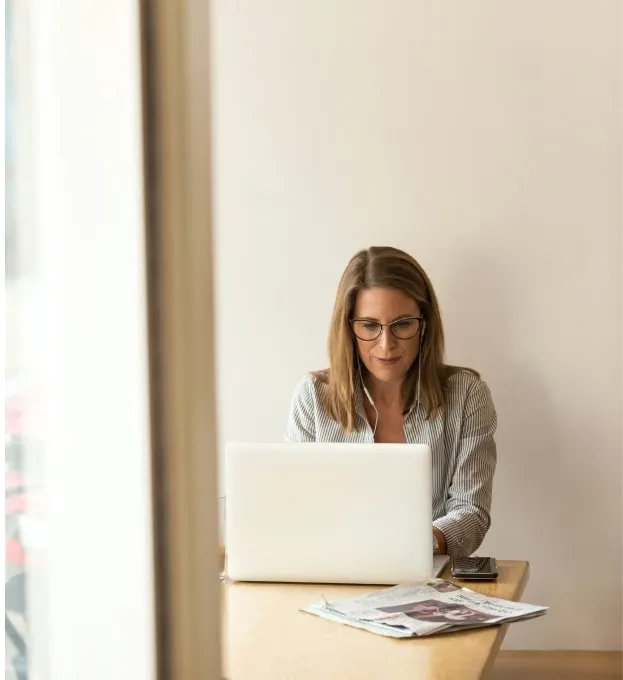 a woman sitting in front of laptop