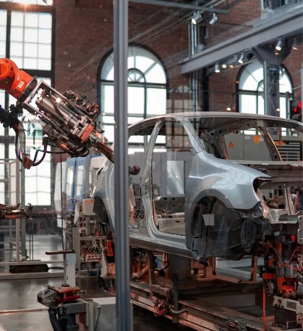 a car being worked on by a robot in a factory
